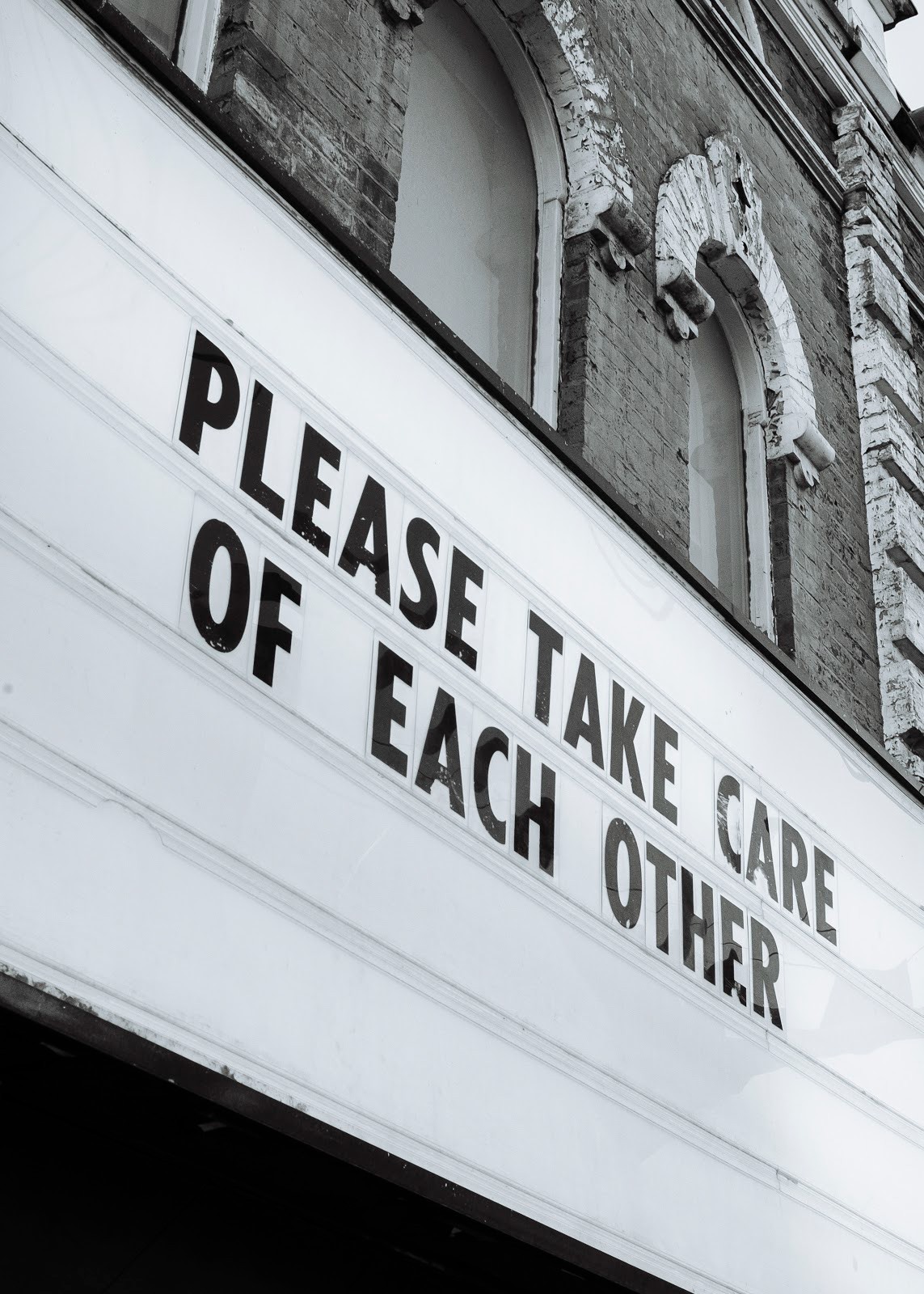 Marquee Sign that reads "Please Take Care of Each Other".