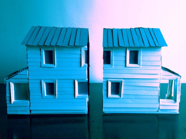 A blue dollhouse split in two.