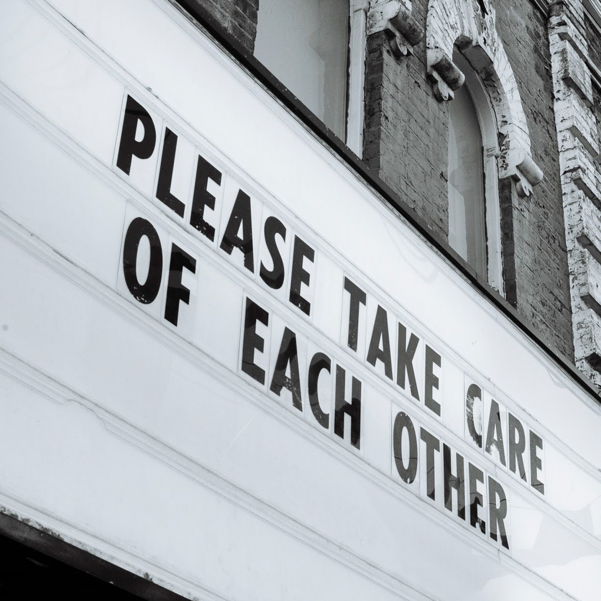 Marquee Sign that reads "Please Take Care of Each Other".