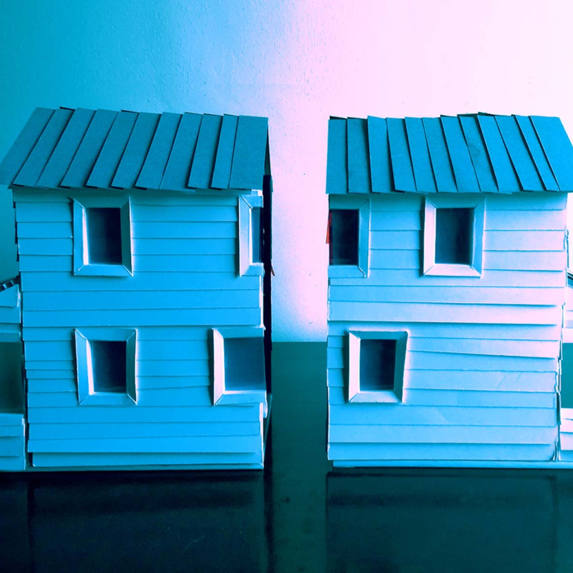 A blue dollhouse split in two.