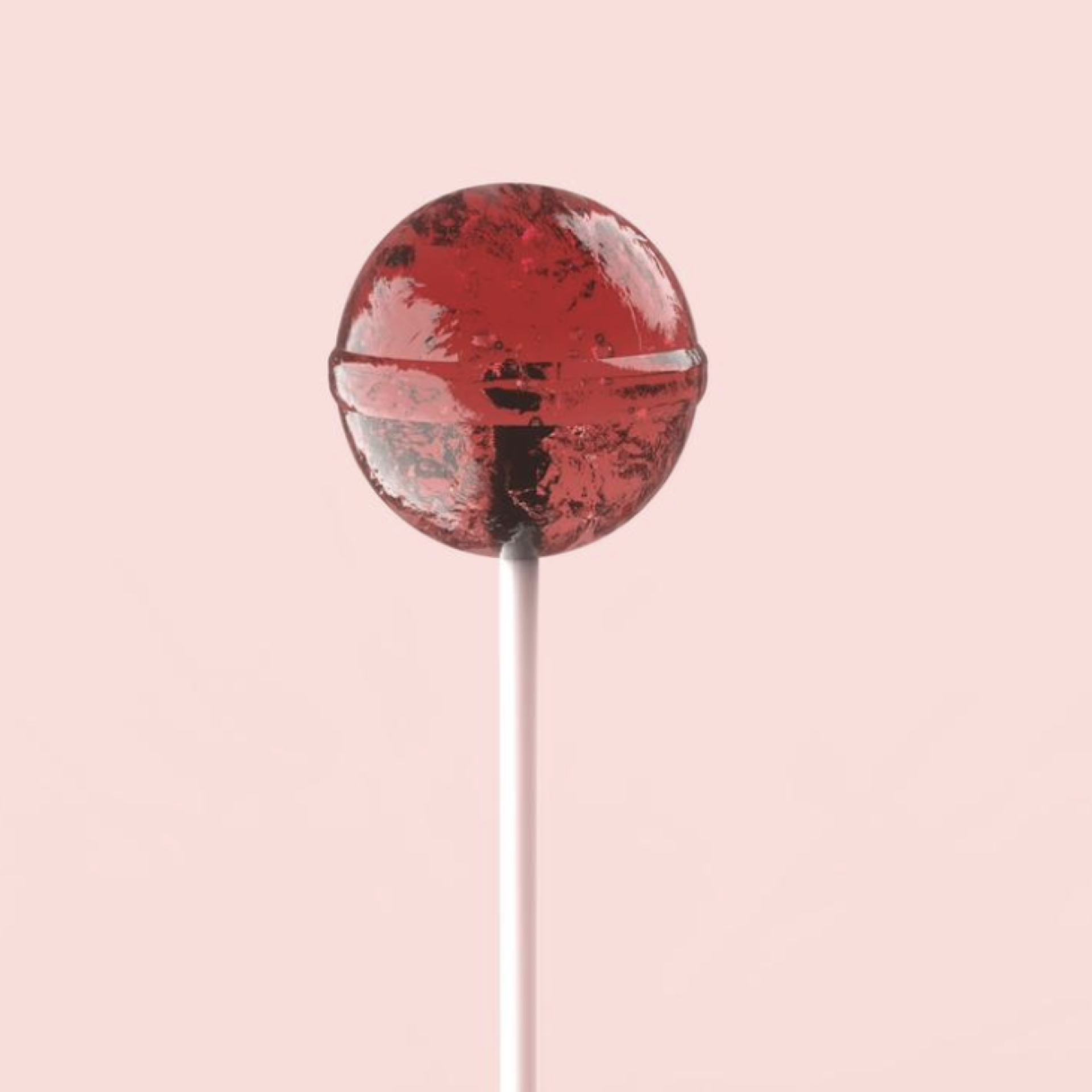 A red lollipop on a pink background.